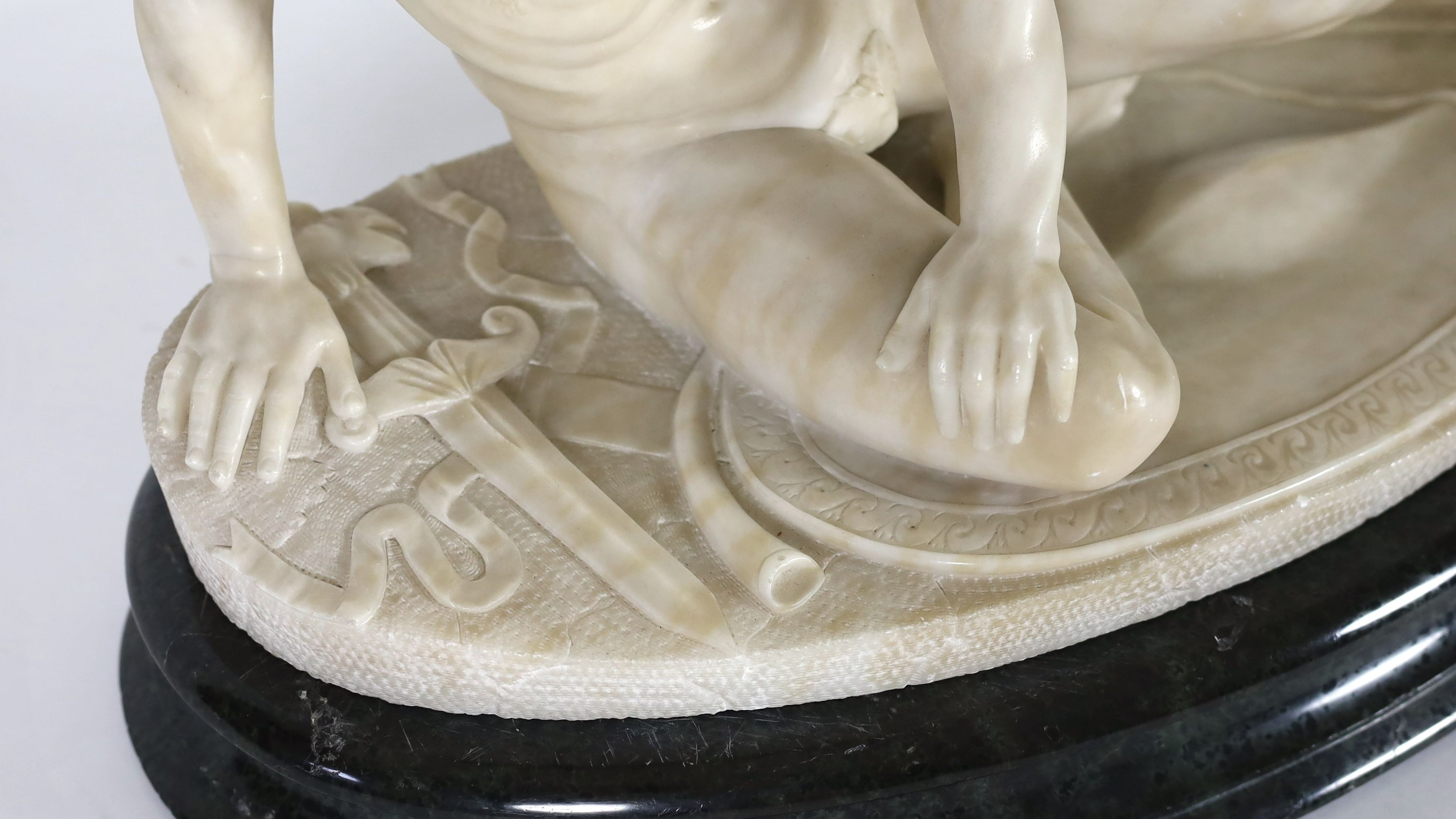 A late 19th century carved alabaster model of The Dying Gaul, width 65cm, height 43cm